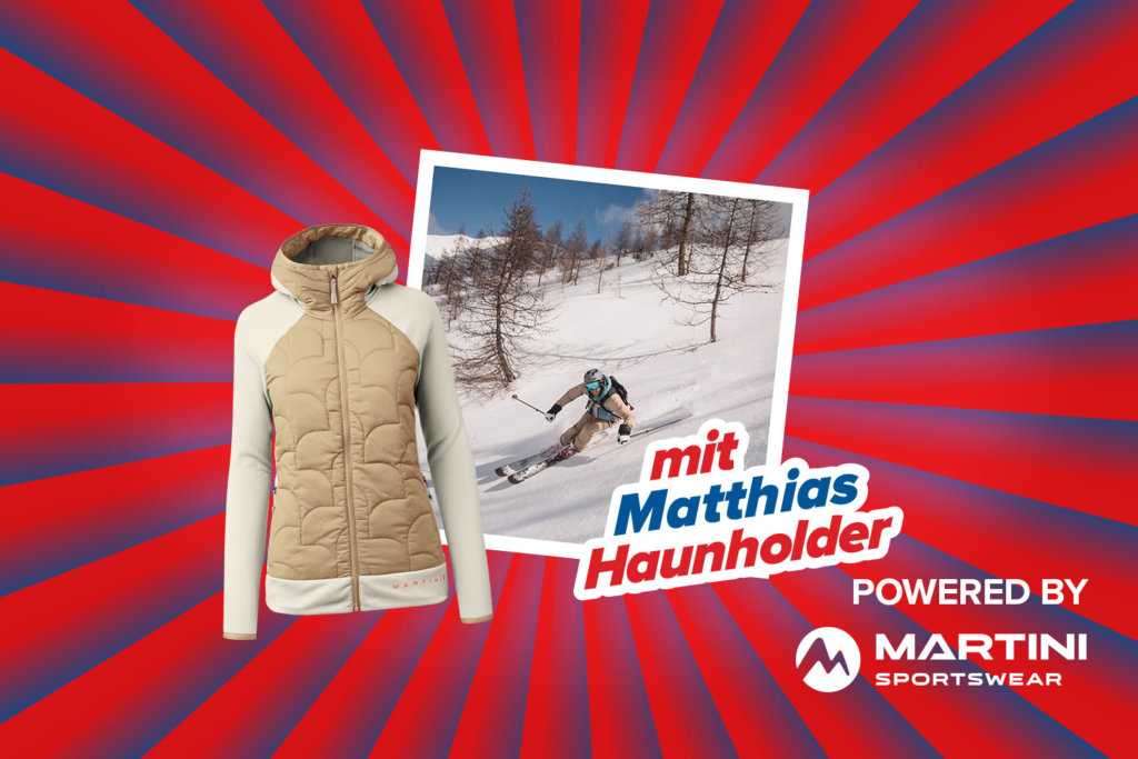 Banner mit rot-blauen Streifen, die sich von der Bildmitte nach außen ziehen. Mitten drin ein Foto vom Freetour Profi Matthias "Hauni" Haunholder auf einem verschneiten Hang zeigt. Ebenfalls im Banner ist die Symbolabbildung einer hellen leichten Jacke, der Schriftzug "mit Matthias Haunholder" sowie ein "Powered by" Schriftzug gefolgt von dem Logo der Marke Martini.